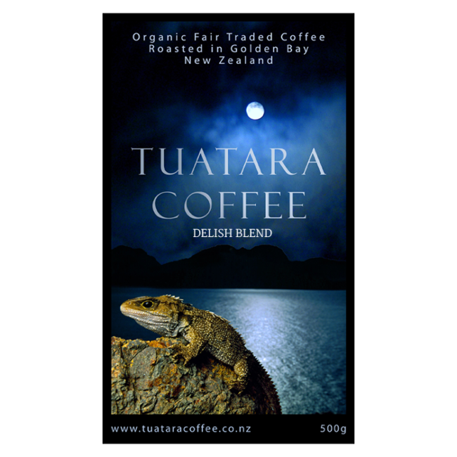 Image of Tuatara Coffee Delish blend packaging showing a tuatara sitting on a rock with water in the background against a night sky.
