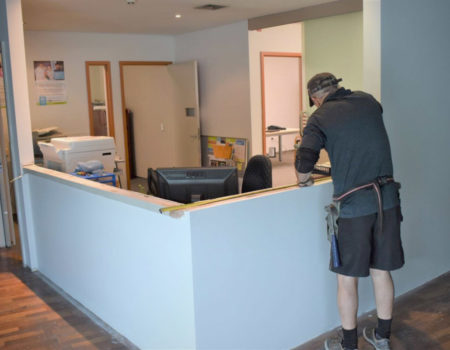 Volunteer Renovates Future Habitat Hub Reception.