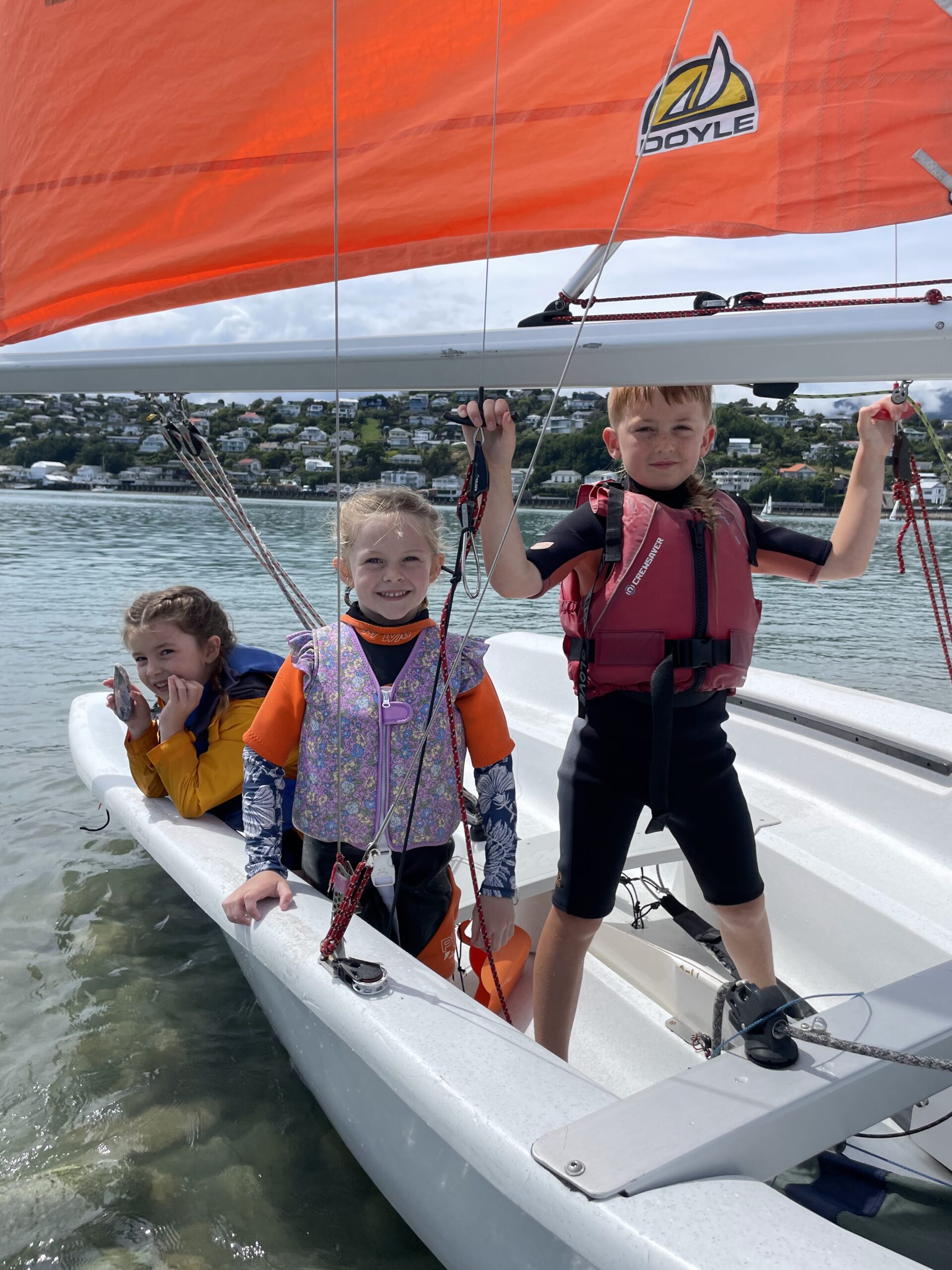 3 small children standing in a boat