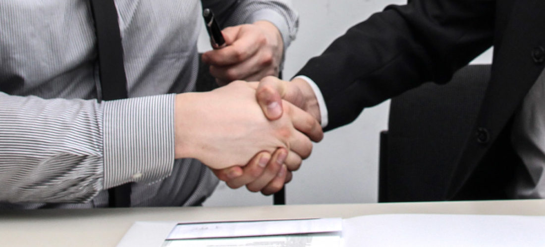 Knapps Lawyers Shaking Hands with contract