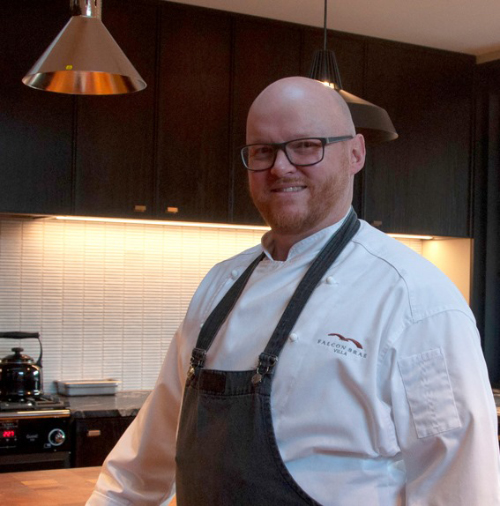 Image of Chef Michael McMeeken standing in an apron in the kitchen at Falcon Brae Villa